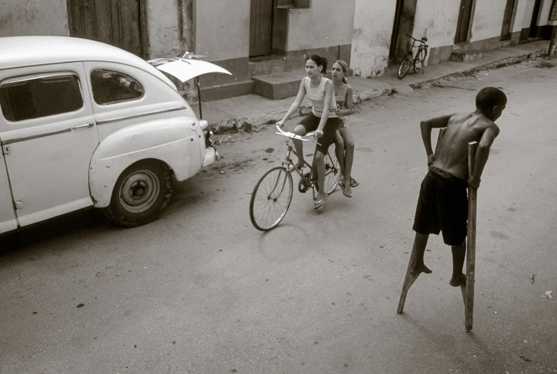 Kid walking on stilts in Cuba