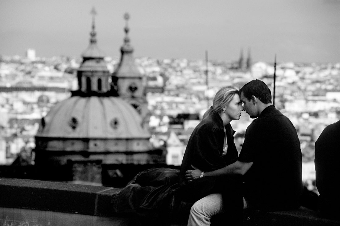 Couple embracing at an overlook of the city of Prague