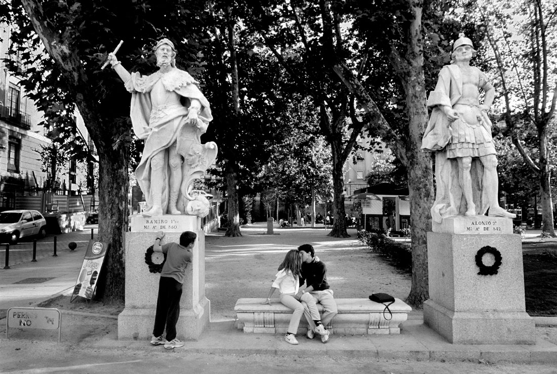 Couple Kissing while kid watches in Madrid Spain